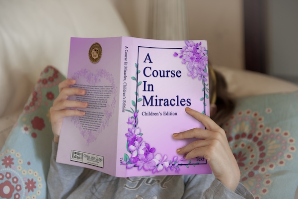 young girl reading A Course in Miracles, children's edition in bed